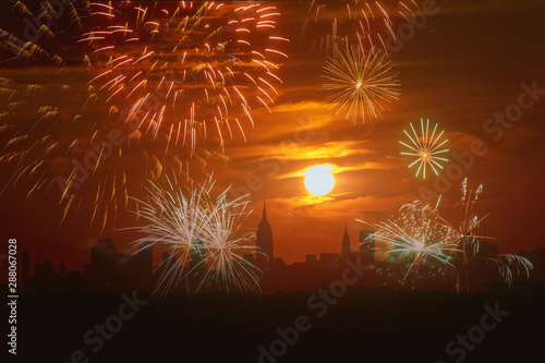 View of Manhattan New York City skyline illuminated amazing fireworks in Independence day