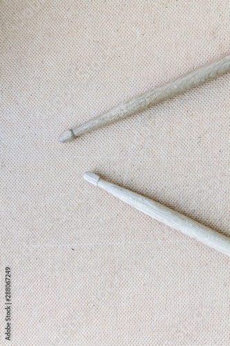 Vertical picture of old used drumsticks on a light background