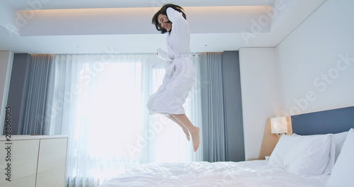 Excited woman jump with bathrobe