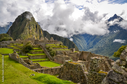 A moment of silence and emptiness at Machu Picchu with the dramatic clouds and mountains in the background