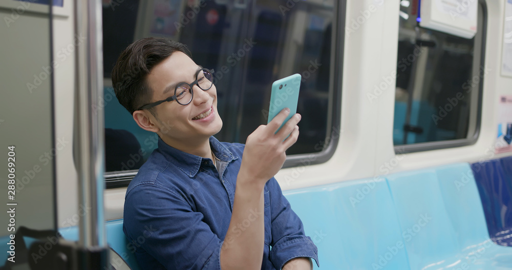 Fototapeta premium man use phone in MRT