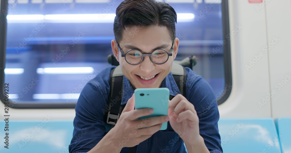 Fototapeta premium man use phone in MRT