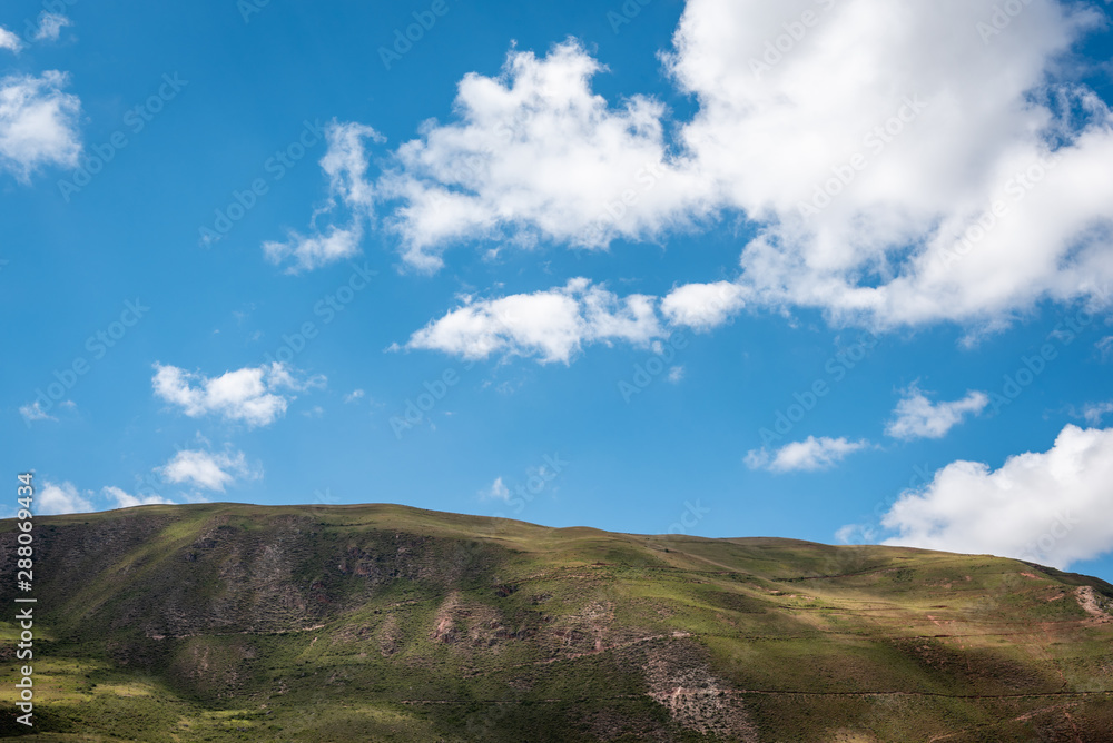 The striking green hilltops, dappled with shade from the clouds above, create an intriguing skyline within the Sacred Valley around Ollantaytambo. The striking green hilltops, dappled with shade from the clouds above, create an intriguing skyline within the Sacred Valley around Ollantaytambo.