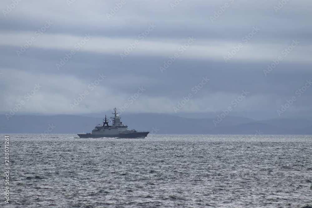 Warship moving on the horizon under the cloudy sky. Warship moving on the horizon under the cloudy sky.