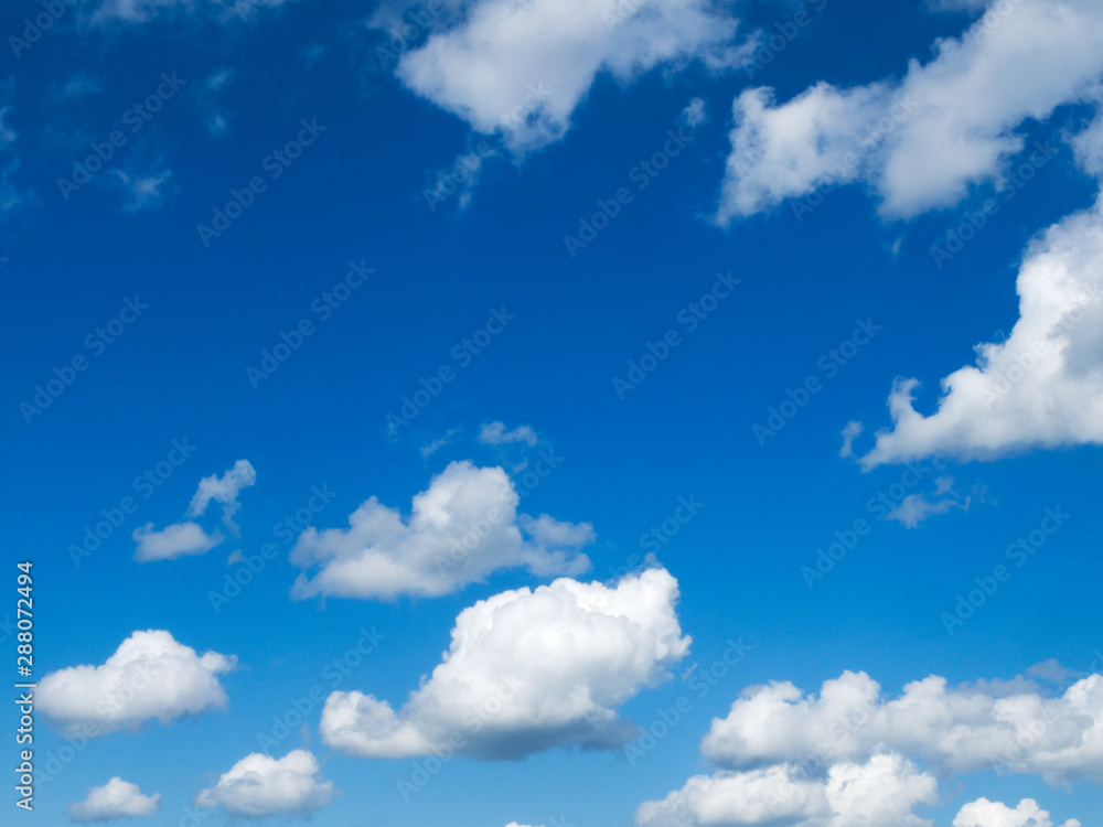 Cumulus humilis clouds with flat bottoms and fluffy tops in a blue sky on a mostly sunny day. Cumulus humilis clouds with flat bottoms and fluffy tops in a blue sky on a mostly sunny day.
