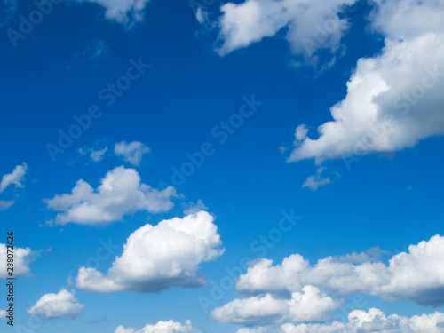 Beautiful blue sky with cumulus humilis clouds with flat bottoms and fluffy tops on a mostly sunny day.