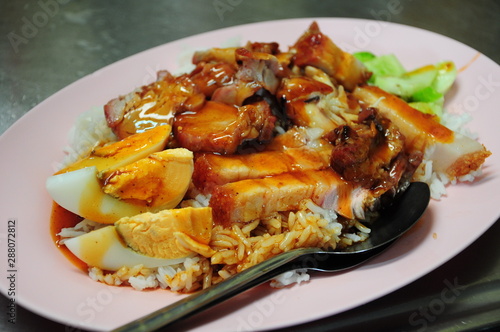 Crispy pork bellies on rice served with gravy, Thai street food
