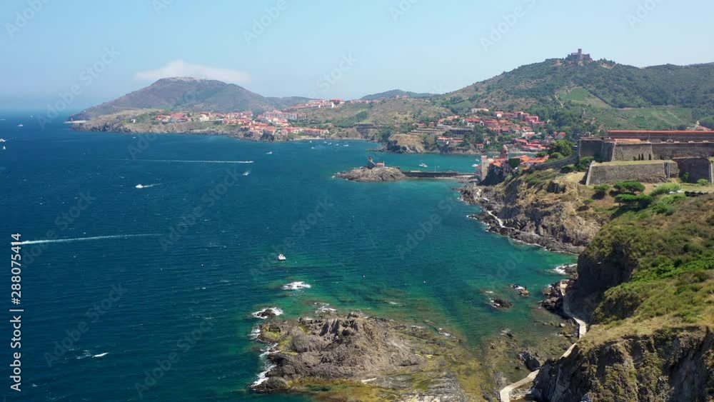 Aerial shot near the historical town and port of Collioure and the French Spanish border at the Mediterranean Sea. Aerial shot near the historical town and port of Collioure and the French Spanish border at the Mediterranean Sea.