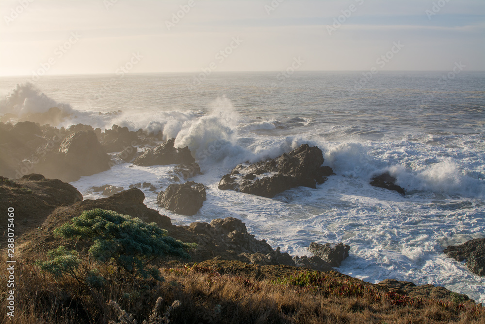 huge waves crashing over Rocky California coast.