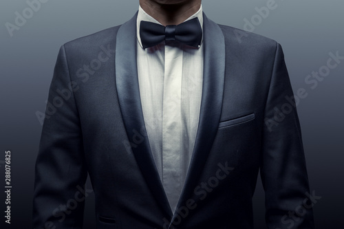Fototapeta Business man in a suit and bow-tie