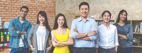 Banner of Group asian employee are standing and looking at camera with feeling confident at workplace company. Portait of Asian creative team posing in workspace. photo