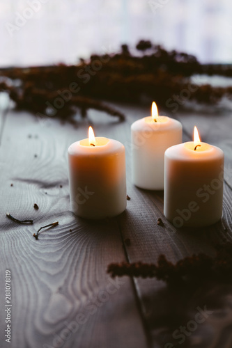 White Candles Burning On Wooden Tabletop