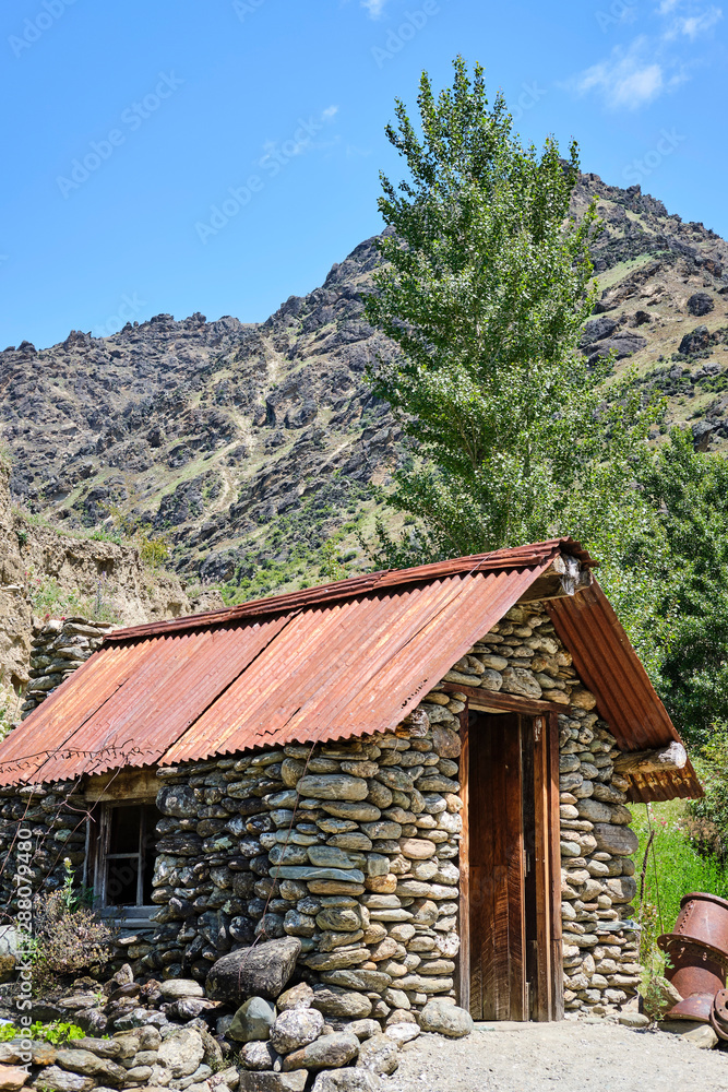 Historic stone shack on mountainside New Zealand