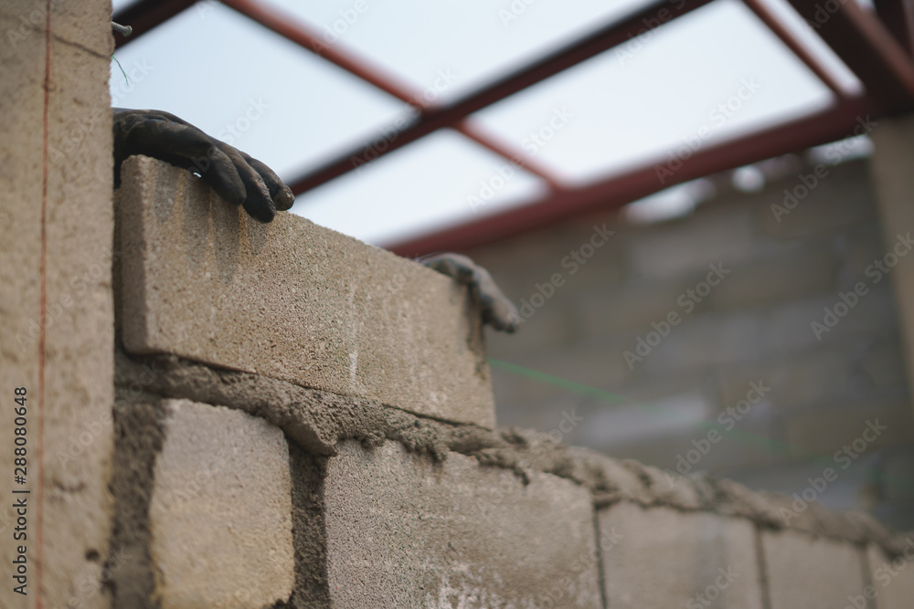 Worker labor building wall with concrete cement.