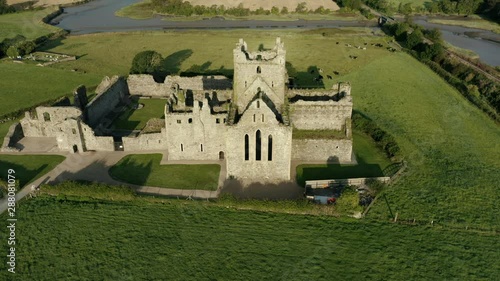 Aerial view, tilt down,  Dunbrody Abbey is a former Cistercian monastery in County Wexford, Ireland. The cross-shaped church was built in the 13th century, and the tower was added in the 15th century. photo