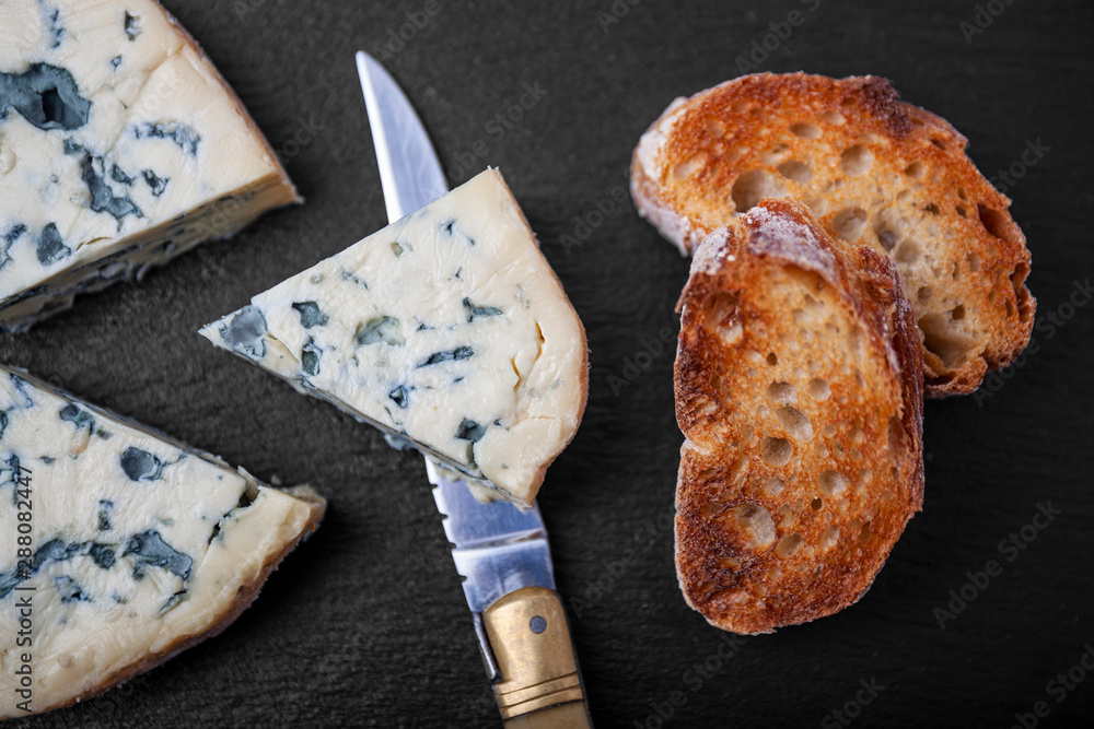 french cow's milk cheese called Fourme d'Ambert on a plate french cow's milk cheese called Fourme d'Ambert on a plate
