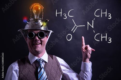 Nerd presenting handdrawn chemical formula of Dimethylacetamide