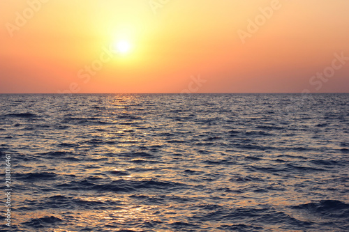 sunset over the sea with waves.