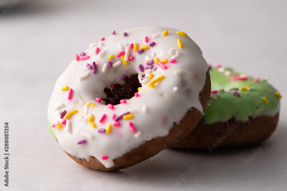 White and green Sprinkled delicious doughnuts. White and green Sprinkled delicious doughnuts.