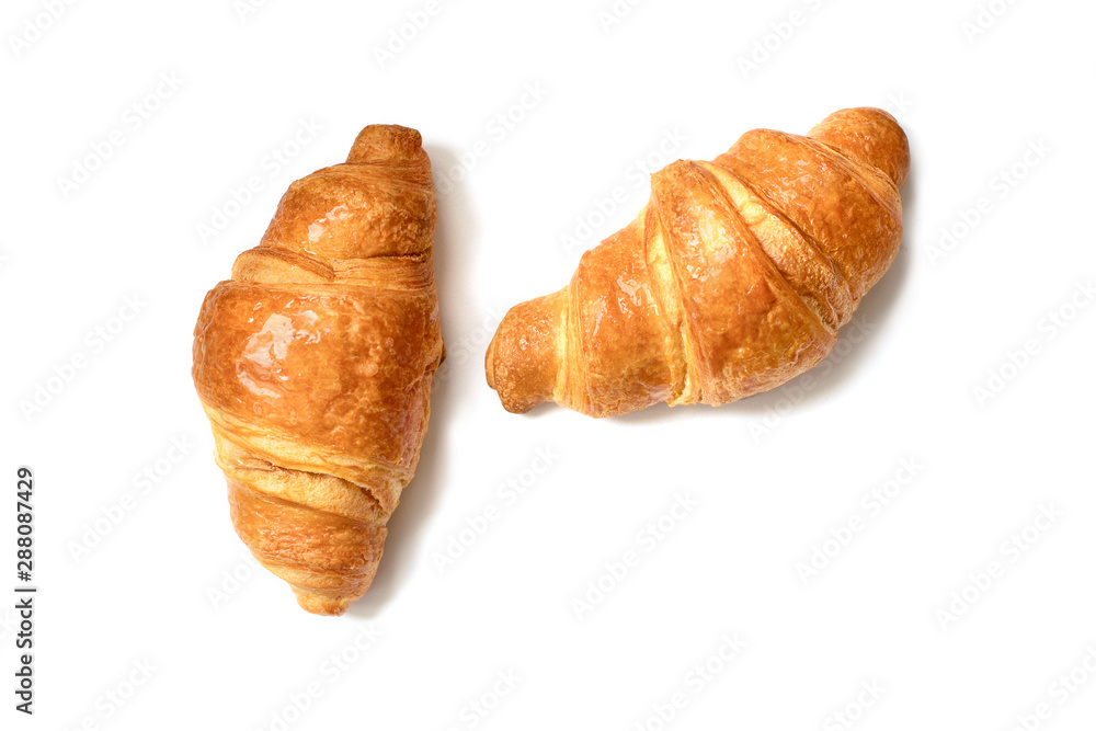 Two plain fresh croissants isolated on white