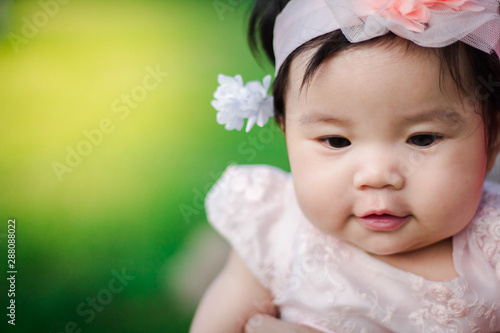 Close up portrait Asian cute baby girl with Natural light background