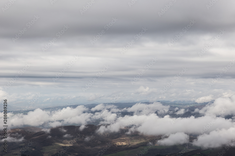 View from above of Umbria valley, with cloudscape both above and below View from above of Umbria valley, with cloudscape both above and below