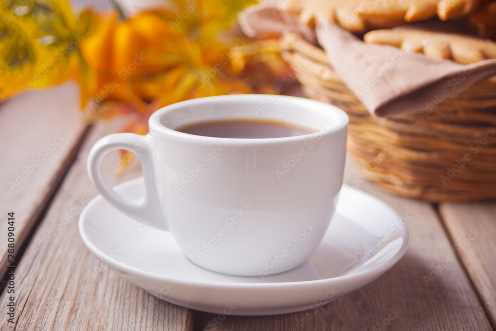 Cup of coffee with autumn leaves. pumpkin on the wooden table. Autumn harvest. Autumn concept. Top view.