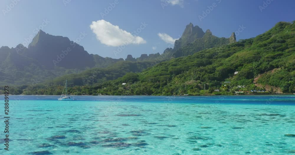 Aerial view of a beautiful blue lagoon and green island mountains in the background, pacific island paradise background Aerial view of a beautiful blue lagoon and green island mountains in the background, pacific island paradise background