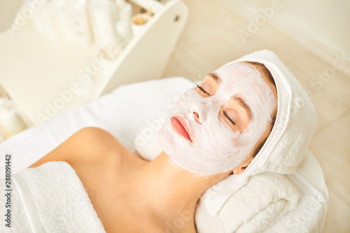 Cosmetic mask on the face of a woman in the spa salon.