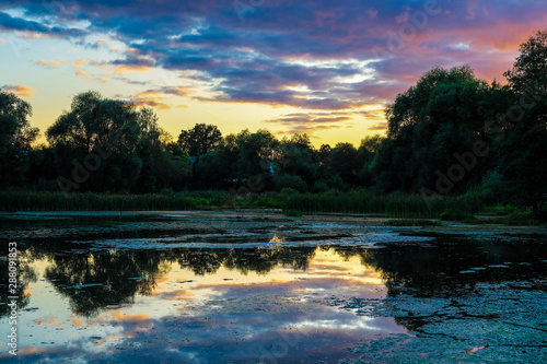 Landscape with the image of a lake at sunset