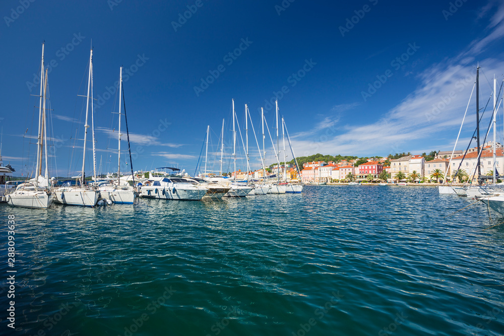 boot moored at the wooden pier in harbour of Losinj town, Croatia.