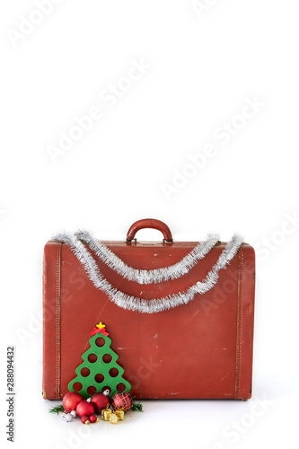 Vintage suitcase with Christmas decorations on white