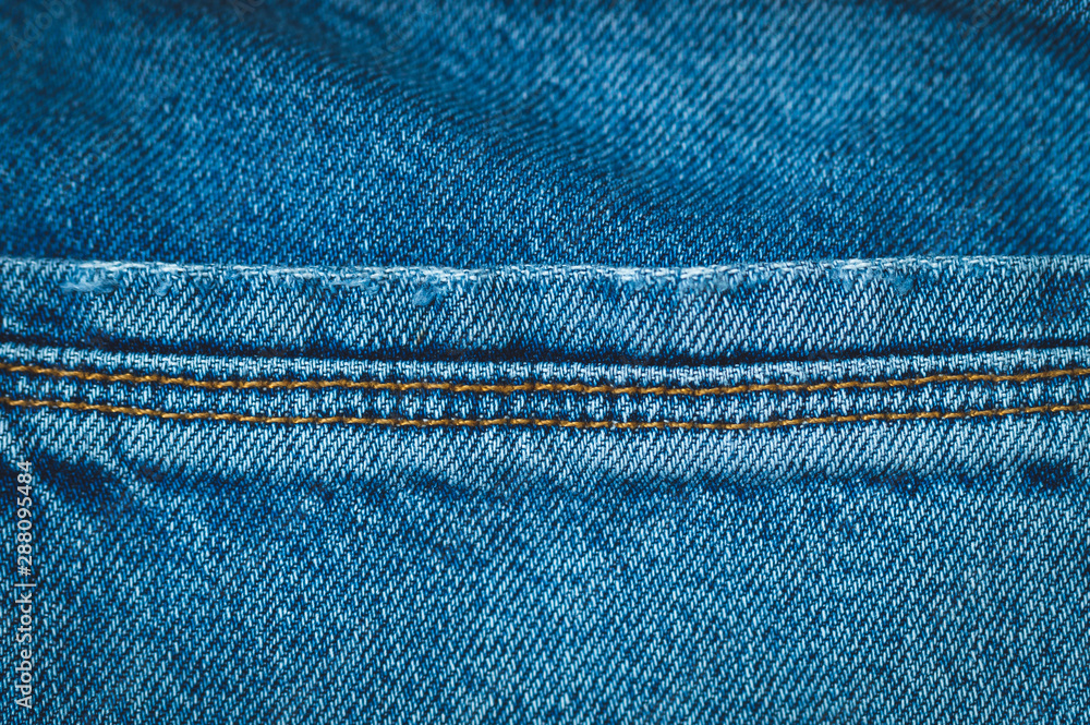 back pocket jeans, macro photo, background image, toning and vignetting image back pocket jeans, macro photo, background image, toning and vignetting image