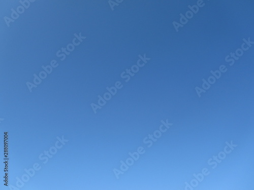Clear blue sky background. The sky without clouds. Abstract blue background.