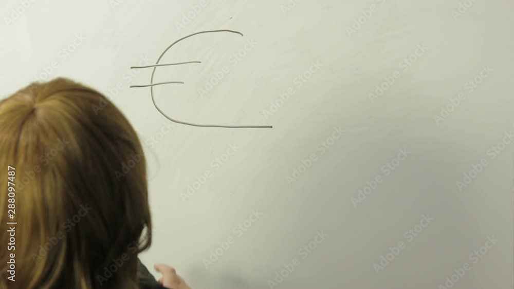 A woman stands with her back and draws a sign of currencies and graphics on a white board. Time laps. A woman stands with her back and draws a sign of currencies and graphics on a white board. Time laps.