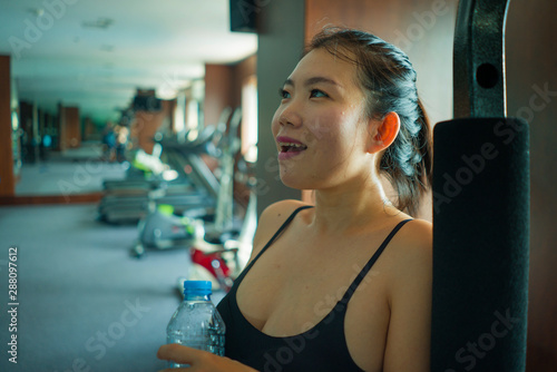 Wallpaper Mural young happy and attractive Asian Korean woman drinking water during fitness center workout smiling cheerful training at hotel gym in body care and healthy lifestyle concept Torontodigital.ca