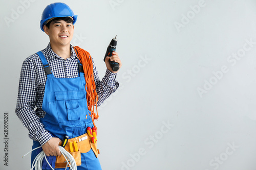 Male electrician on white b...