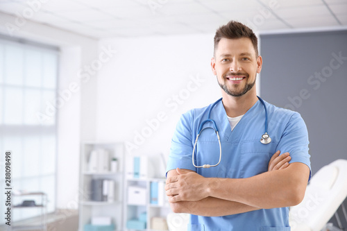 Male nurse with stethoscope in clinic photo