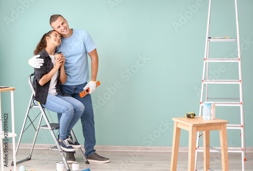 Happy young couple resting during repair of their new house