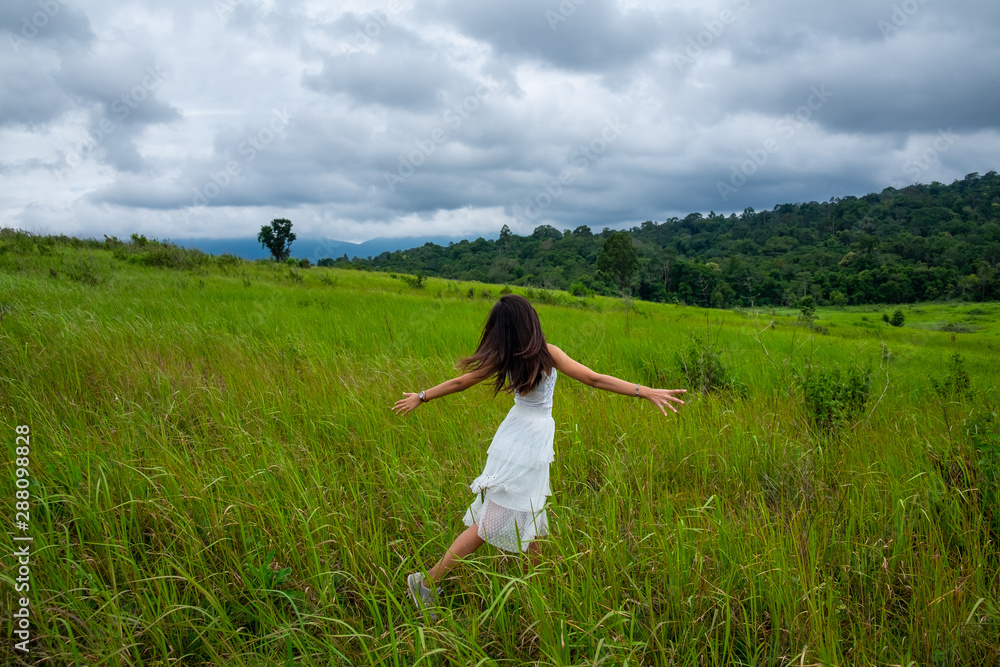 Beautiful young woman enjoying sun and fresh air in a field,happy day Beautiful young woman enjoying sun and fresh air in a field,happy day