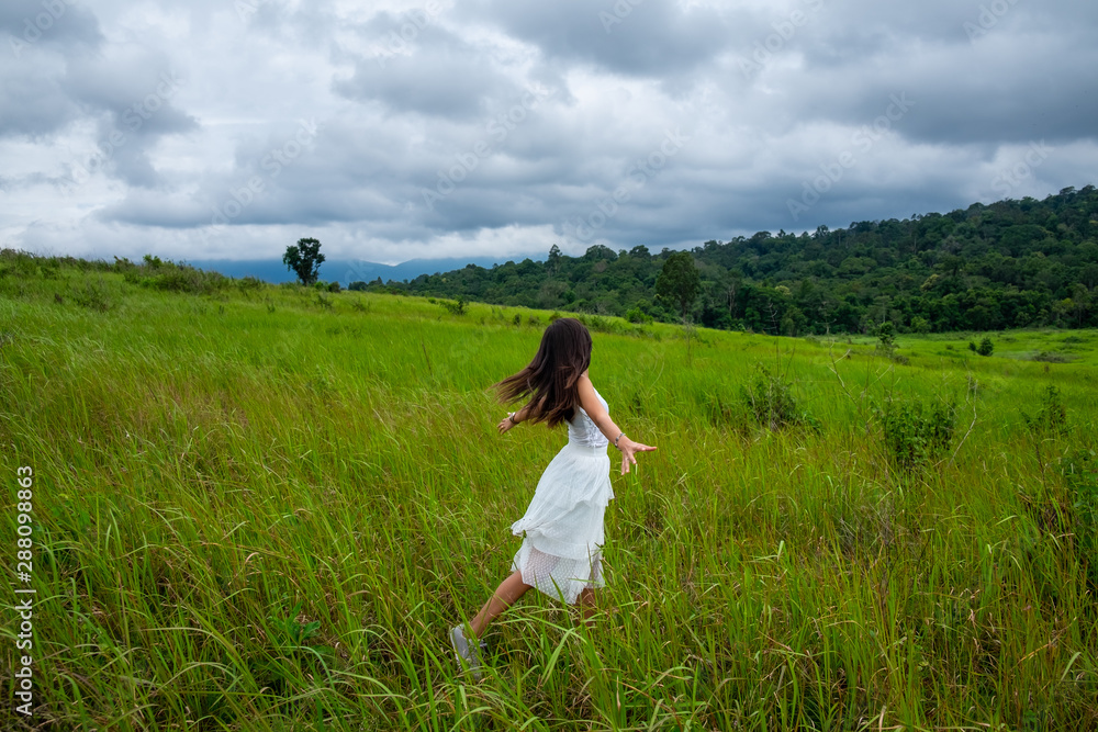 Beautiful young woman enjoying sun and fresh air in a field,happy day Beautiful young woman enjoying sun and fresh air in a field,happy day