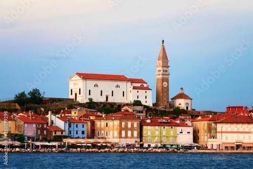 Variegated buildings and church in Piran.