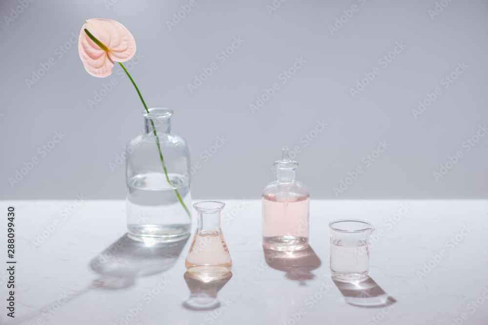 Beautiful composition with perfume samples and flowers on table Beautiful composition with perfume samples and flowers on table