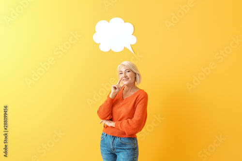 Картината върху платно Stylish mature woman with blank speech bubble on color background