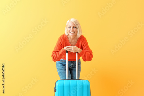 Mature woman with suitcase ...