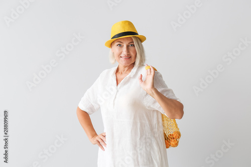 Mature woman with eco bag o...