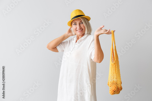 Mature woman with eco bag o...