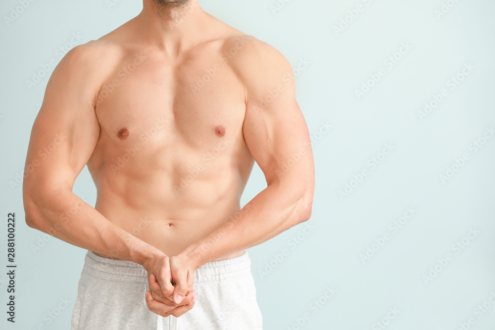 Handsome muscular man on color background. Weight loss concept Handsome muscular man on color background. Weight loss concept