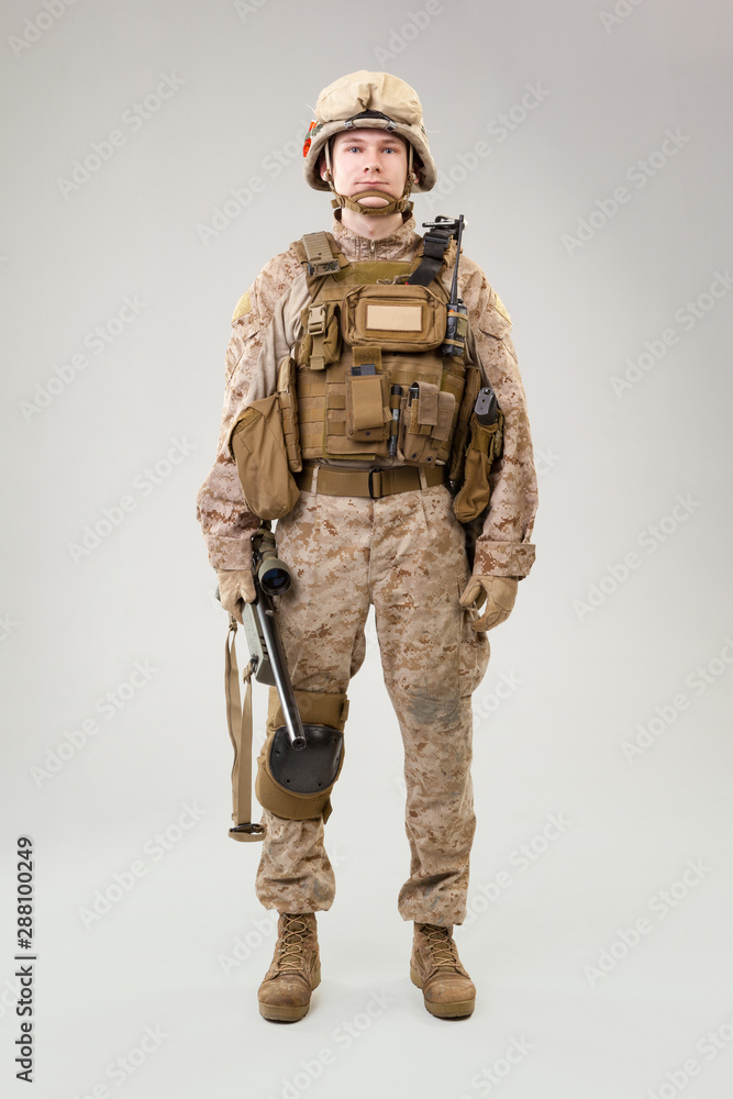 Studio shoot of modern infantry soldier, U.S. marine rifleman in combat uniform, helmet and body armor Studio shoot of modern infantry soldier, U.S. marine rifleman in combat uniform, helmet and body armor