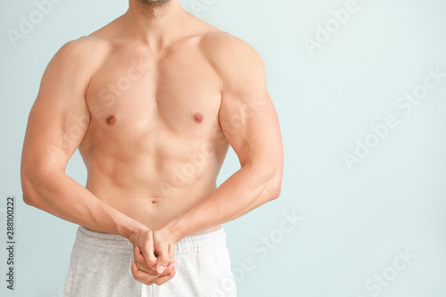 Handsome muscular man on color background. Weight loss concept